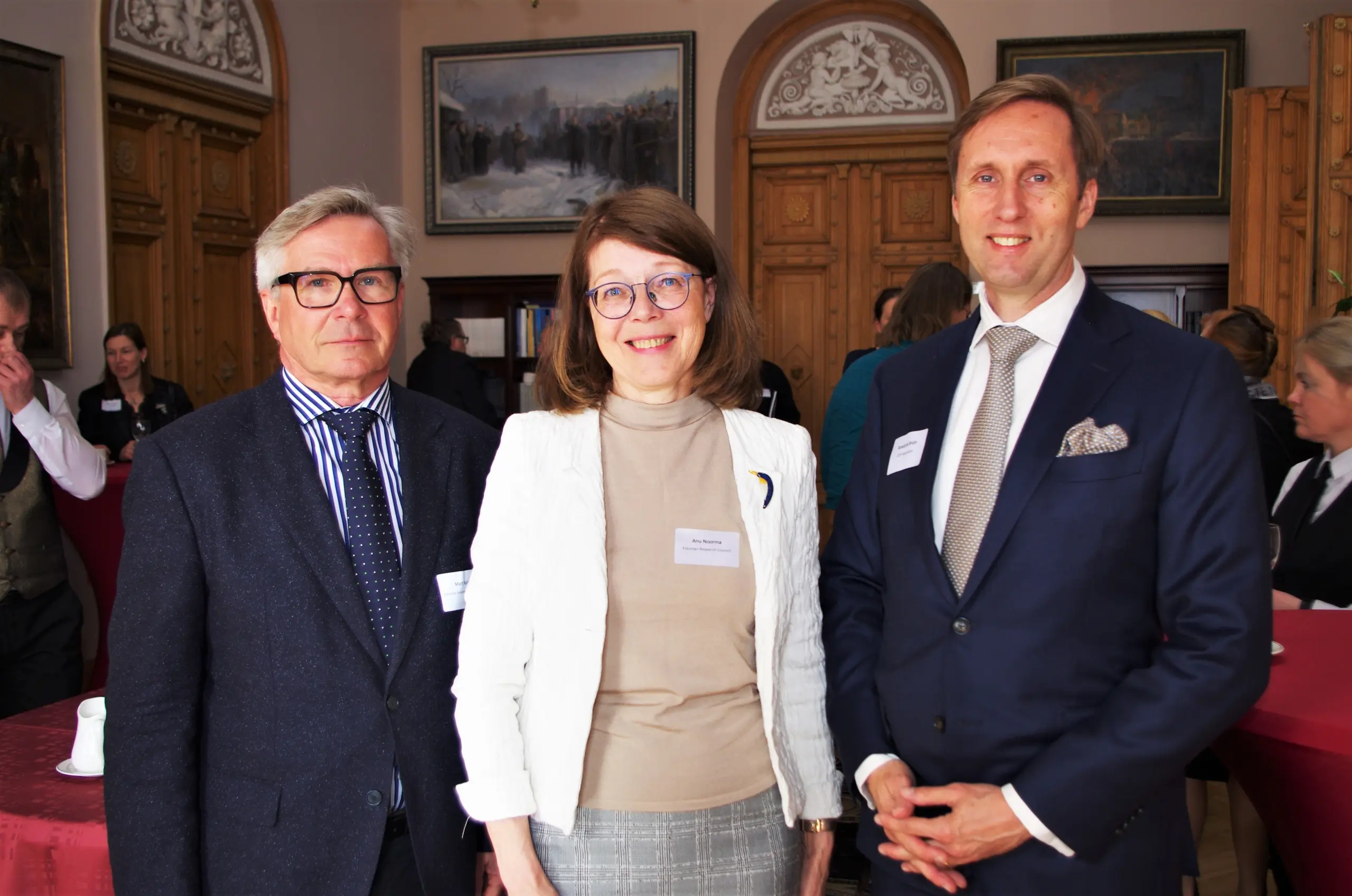 Group photo of two men and one woman inside the Estonian Academy of Sciences