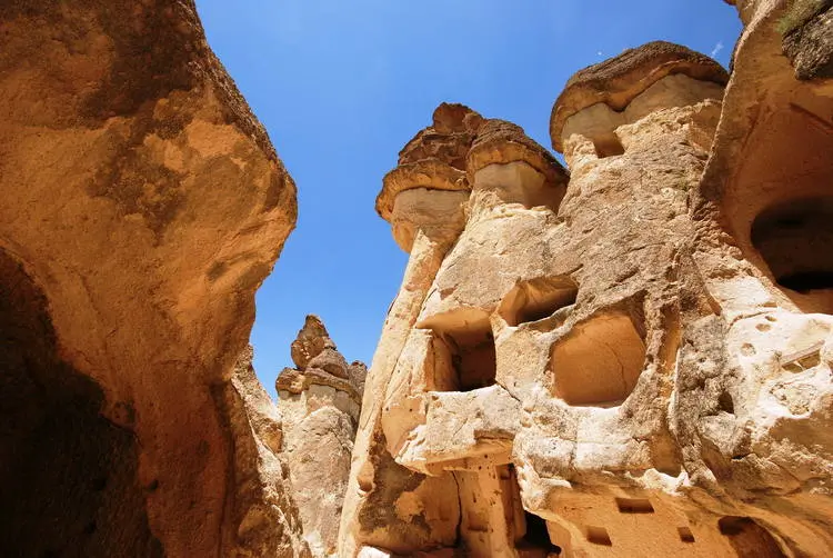 yellow rock with caves