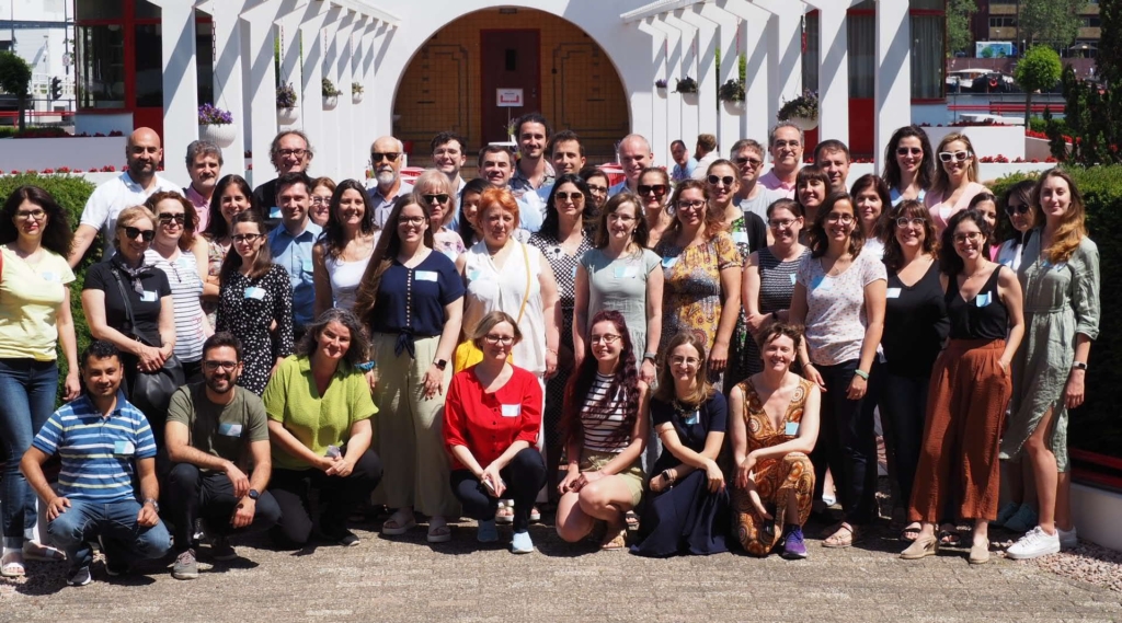 Group photo of 40+ tuberculosis researchers posing for a group photo outside during a workshop