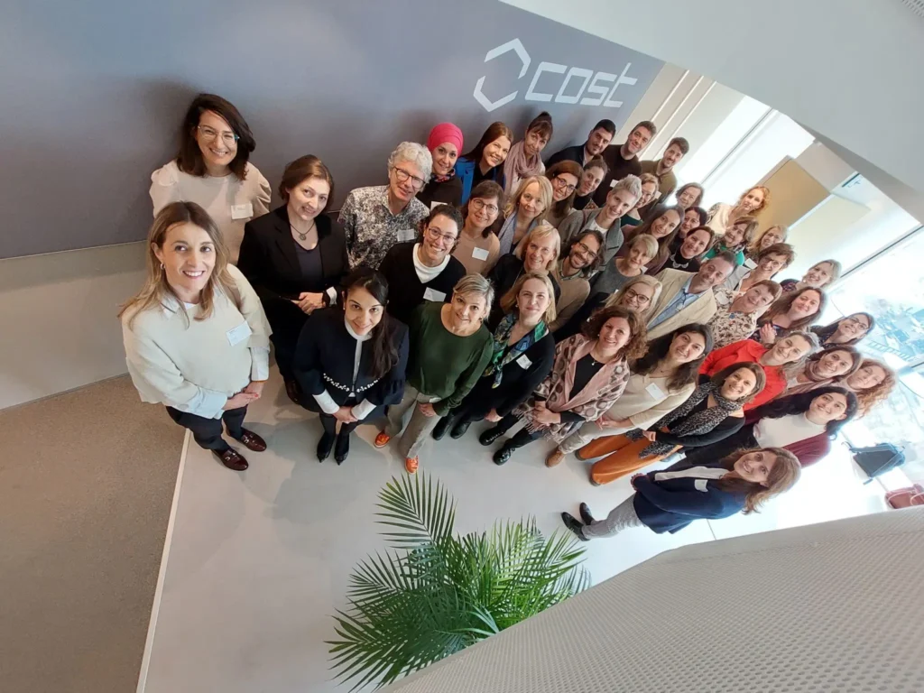 A group of 30+ researchers and innovators standing together for a group photo at the kickoff of their new research network in the COST premises.