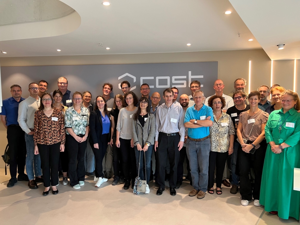 A group of 30+ researchers and innovators standing together for a group photo at the kickoff of their new research network in the COST premises.