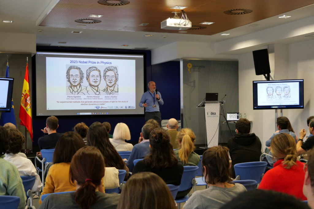 A man presenting in front of an audience